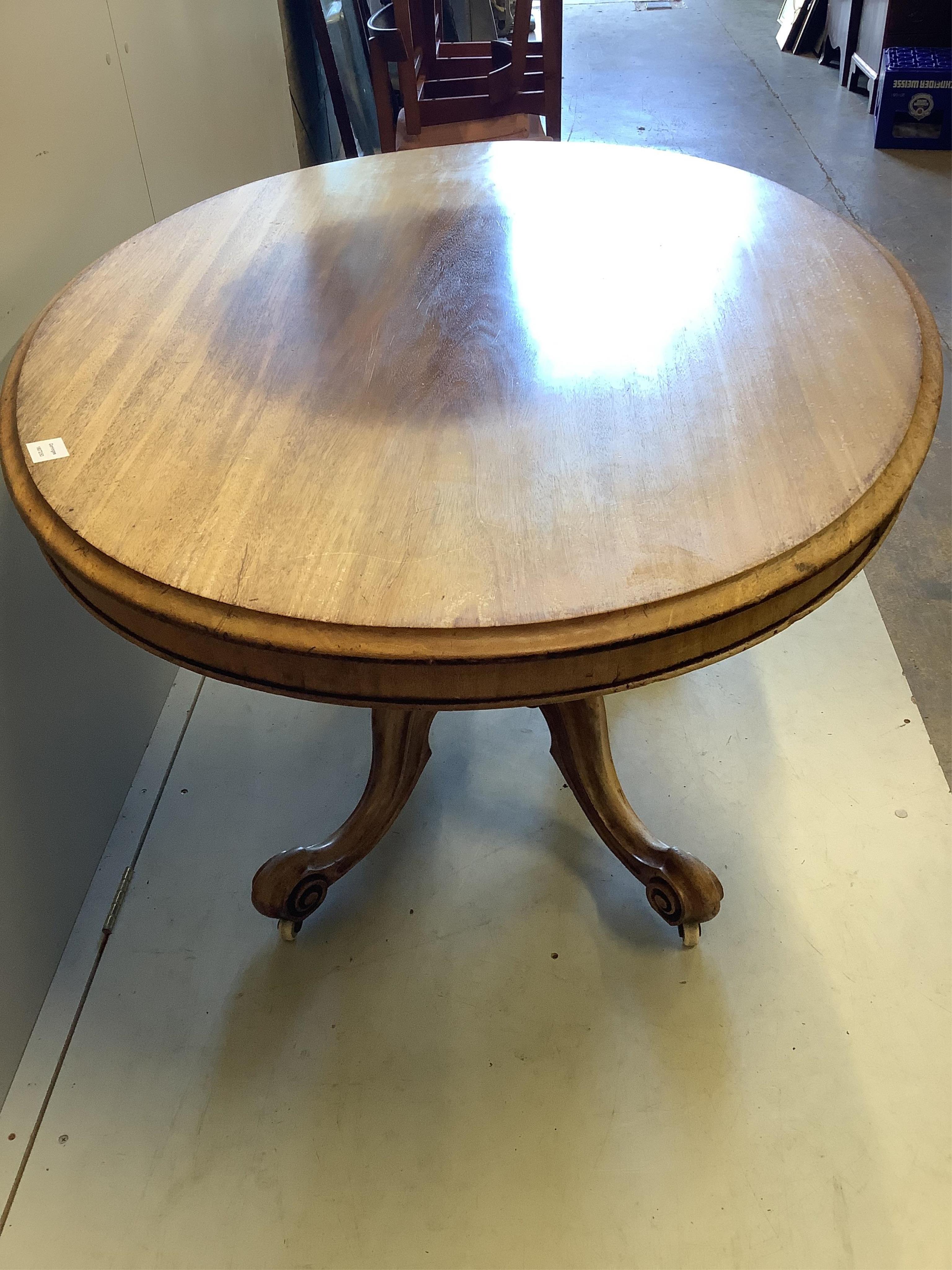 A Victorian faded mahogany oval tilt top loo table, width 137cm, depth 103cm, height 73cm